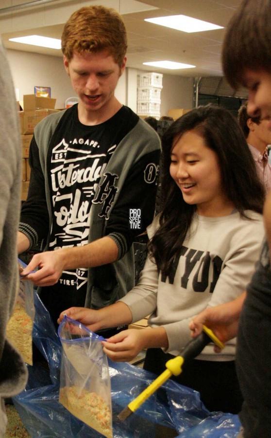 Seniors Scott Workman and Ashley Park bag rice and vegetables. | Mallory Spangler photo
