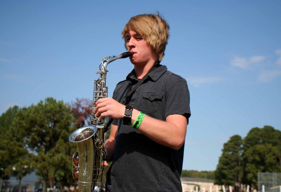 Nic Townsend playing saxophone in the band.