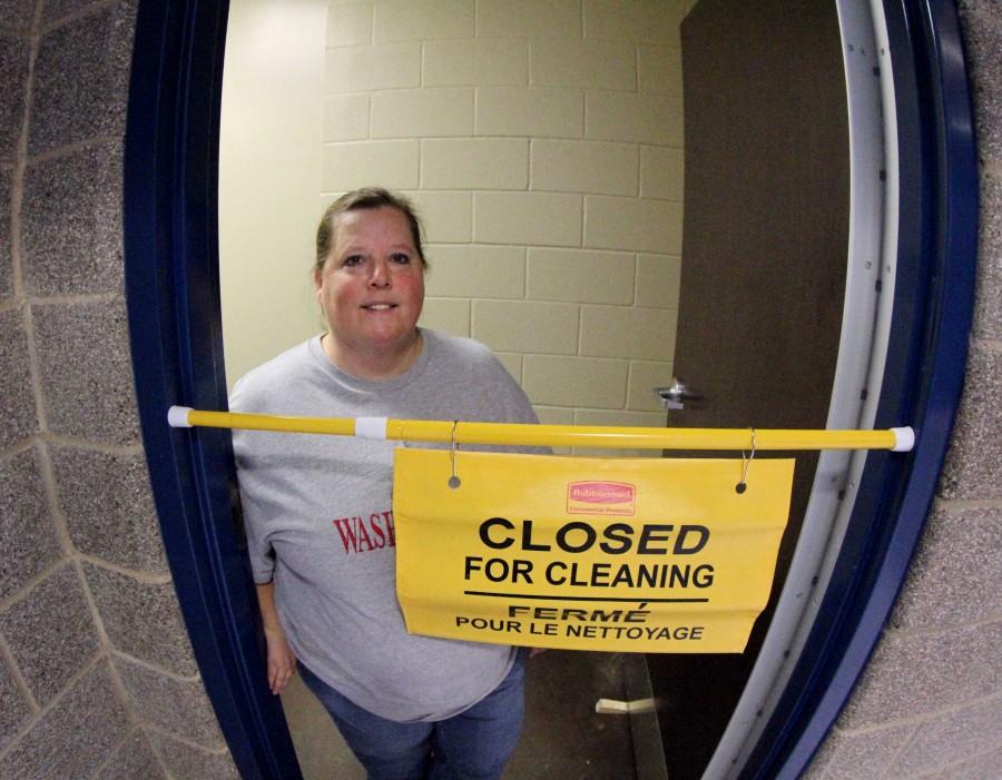 Custodian Sherri Chudy cleaning the bathrooms, one of the many tasks she has to perform. | ashley collins photo 