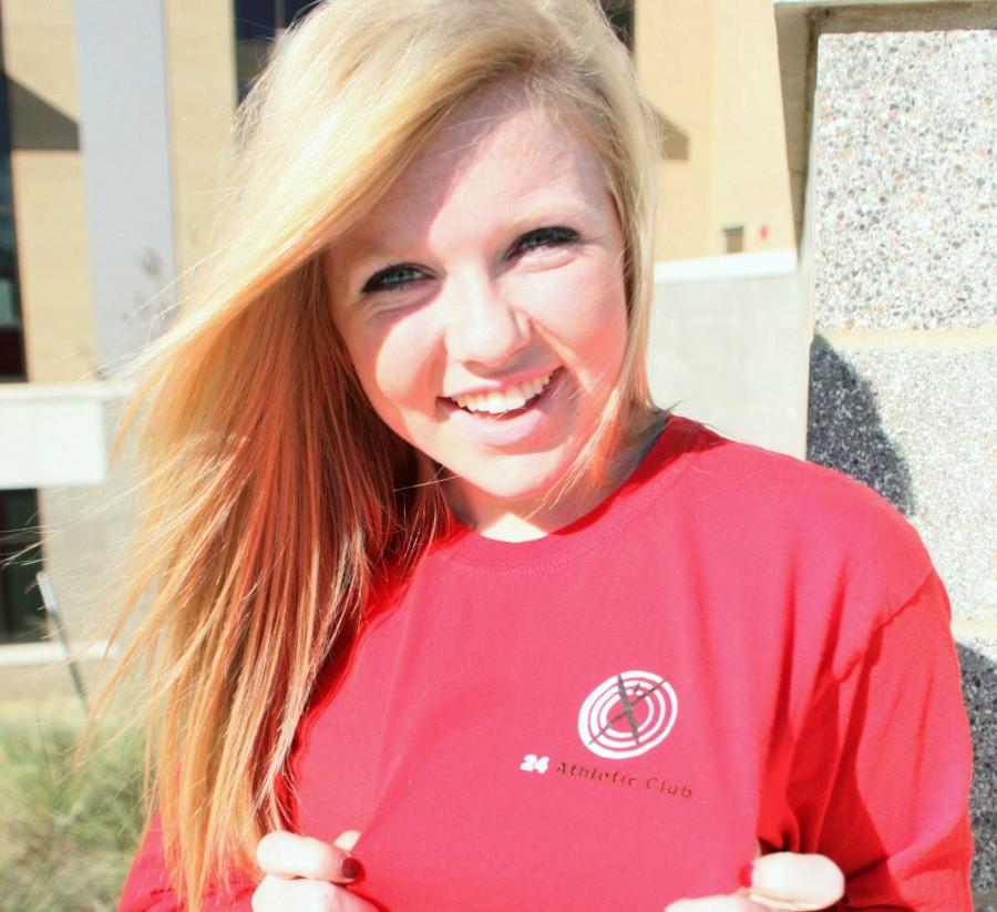 Sporting her 24 Athletic Club shirt, junior Anna Smith said she enjoys her job at the gym. | lauren sanders