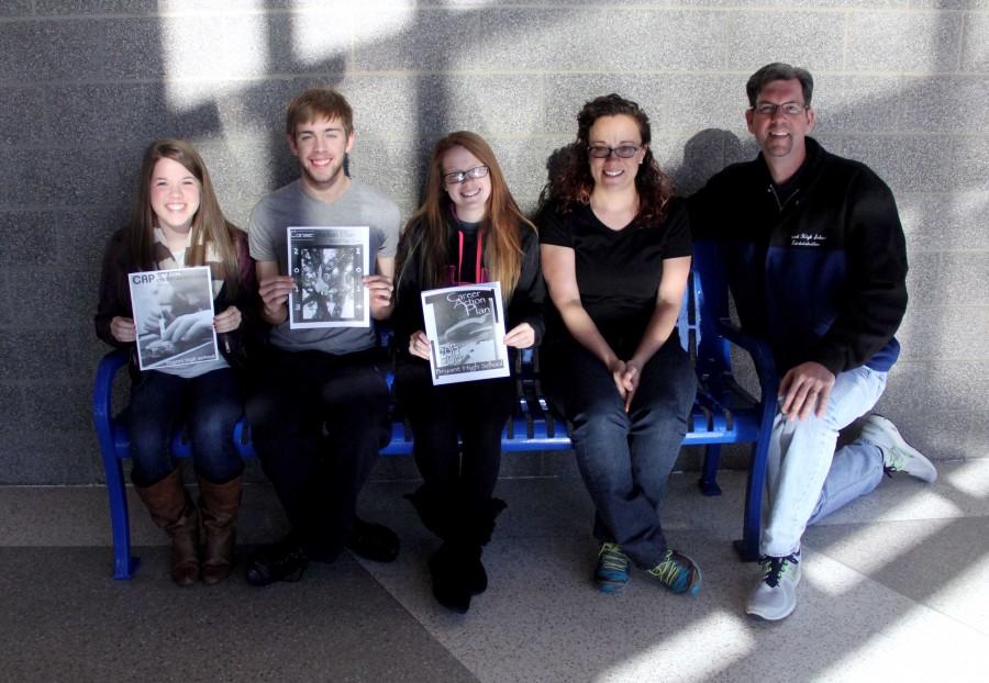 Holding their winning CAP booklet designs, seniors Amber Easterly, Drew Hopson and Megan Rodgers sit beside design teacher India Childress and principal Jay Pickering.