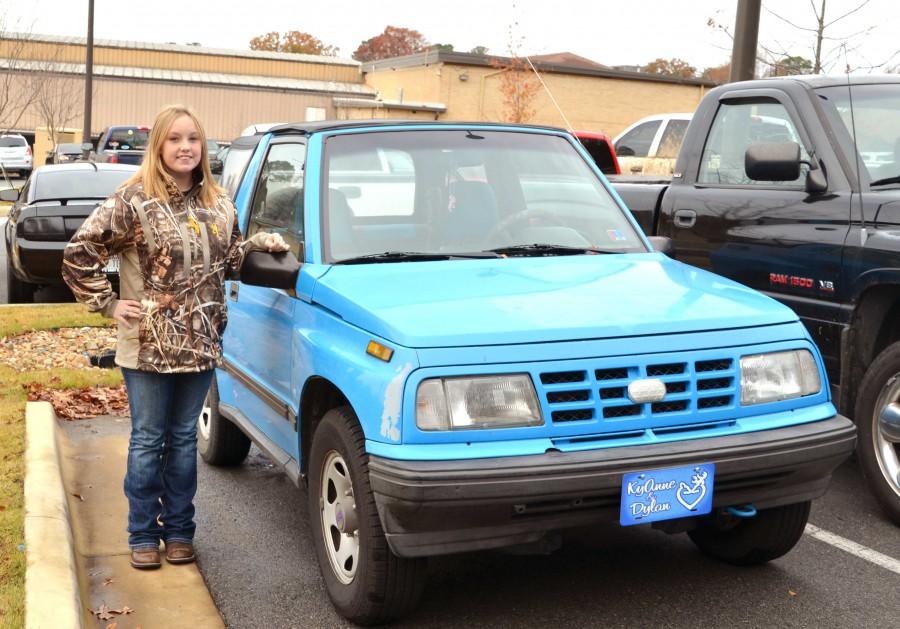 Showing off her bright blue car, junior KyAnne Lawrence drives a 1992 
Geotracker | madline 
colclasure photo