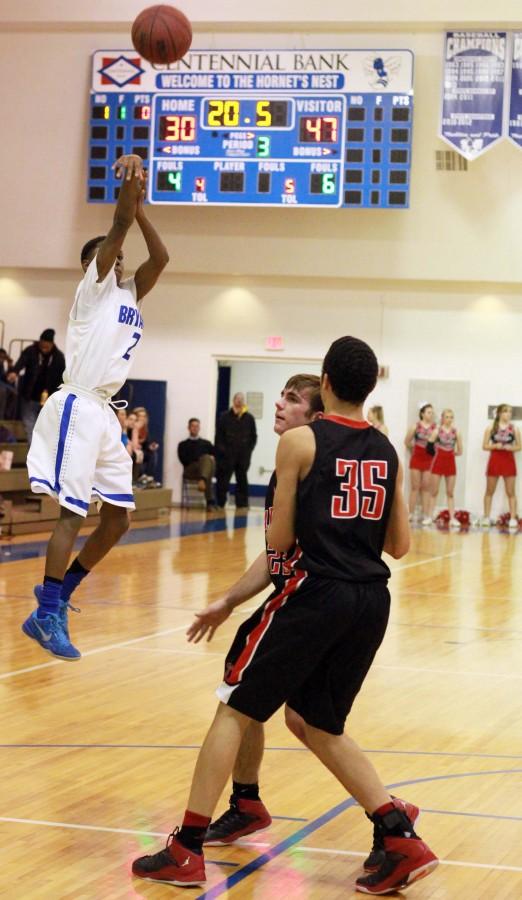 Desmond Duckworth shoots a shot over two Russelville defenders | photo Madison Morehead