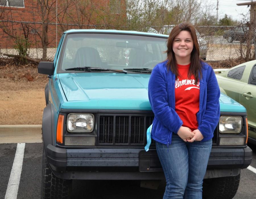 showing off her turquoise car, sophomore Abigail Sudbury drives her favorite color to school every day | Madeline Colclasure photo