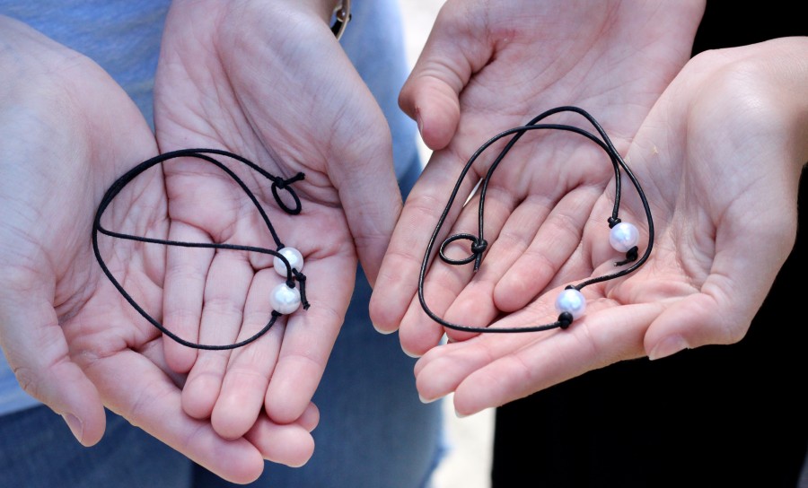 Two necklaces in the hands of juniors Abby Catton and Presli Pendergrass. | Julia Nall photo