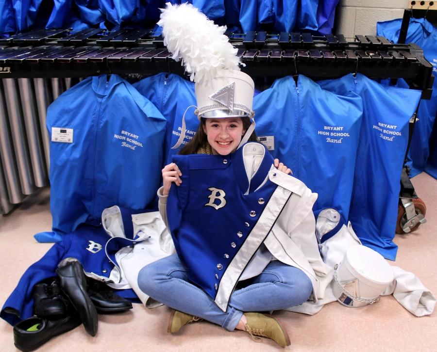 Junior drum major Sarah Sellers sits with old jackets in the uniform room. [The old uniforms] are falling apart, Sellers said. Our physical appearance has a big impact on how we are judged at competitions. Weve worked so hard to have people notice how much we need the new uniforms. Sellers participated in fundraisers such as selling cheesecakes and beef jerky sticks. | Julia Nall photo