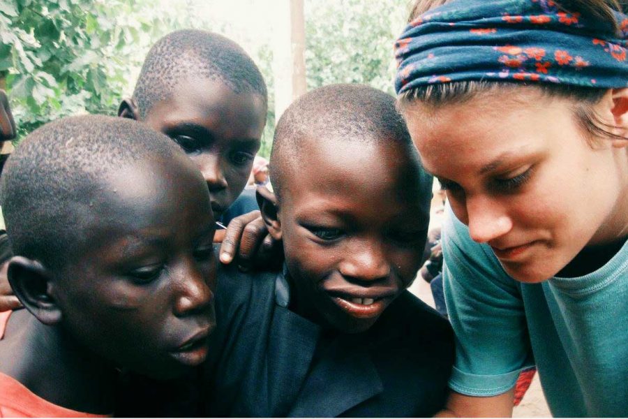 Junior Madison Treat with children in Uganda.