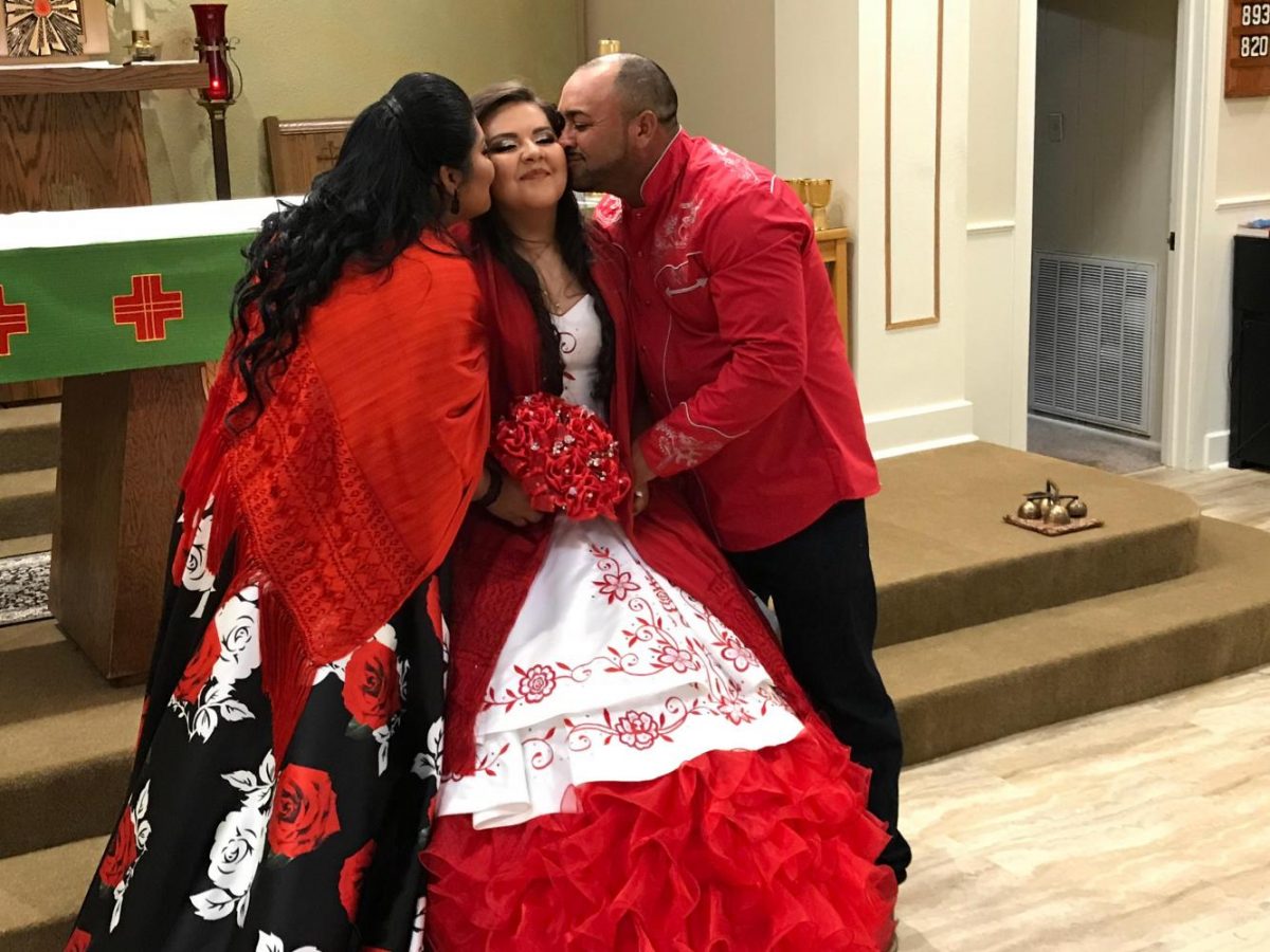 Kissing her cheeks, sophomore Yamilet Montoyas parents pose for a picture at her quinceanera. Montoya celebrated her 15th birthday Aug. 12 in Little Rock. I had a church ceremony with my friends and family who joined me, Montoya said. It was so much fun and a great experience. Photo| Courtesy of Yamilet Montoya 