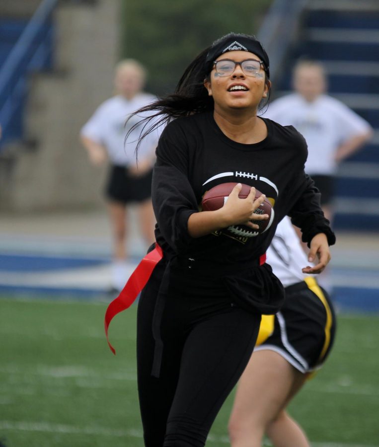 Senior Emilie Gallegos runs with the ball.