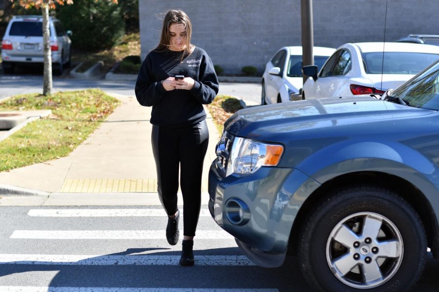 Distracted+by+her+phone%2C+senior+Madison+Green+almost+gets+hit+by+an+incoming+driver.