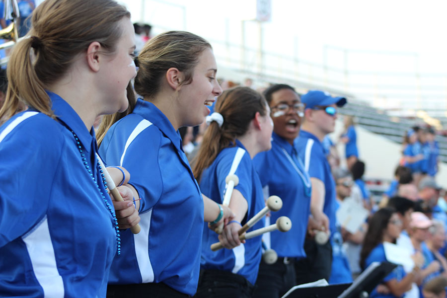The Legacy of Bryant bass line joins arms as they sing the Alma Mater at the 2018 Salt Bowl.
