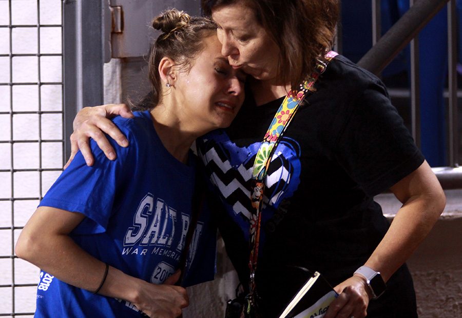 Reunited with her mother, Melissa Boswell, senior Sydney Boswell cries after the chaos at the Salt Bowl Aug. 25.