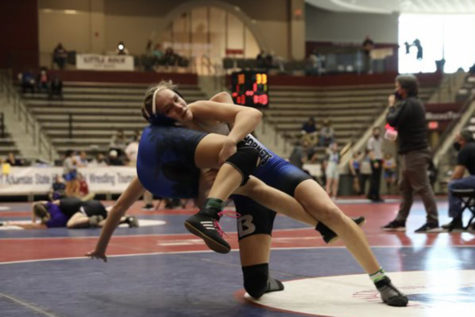 At the state wrestling tournament, sophomore Presley Givens takes down an opponent. Givens was the only female wrestler on the team.