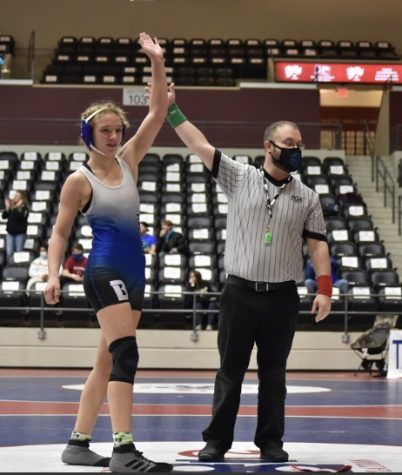 Junior Presley Givens wins a match at last year’s state wrestling championship.