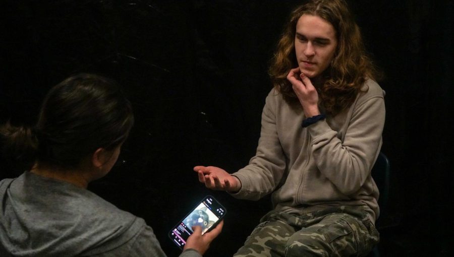 Student Preston Gibson speaks with distracted student Angel Santana.