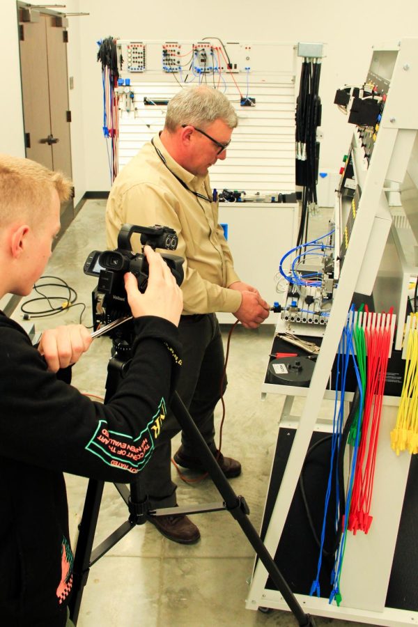 Broadcasting student, Austin Williams (12), films an Industrial Engineering display at the Saline County Career Center. 