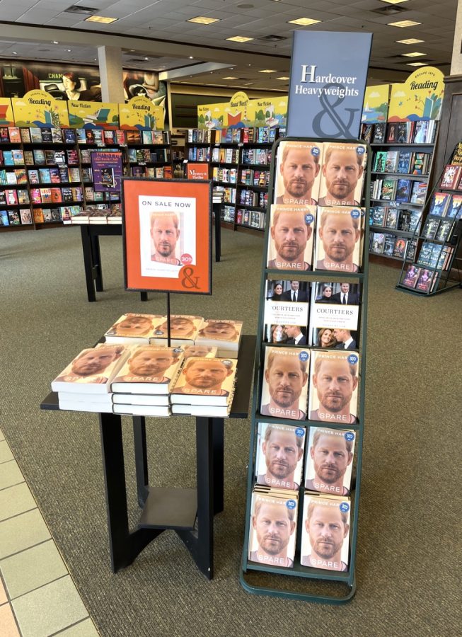 Molly Kitchens photographs a display of Prince Harry’s memoir, Spare, at Barnes & Noble