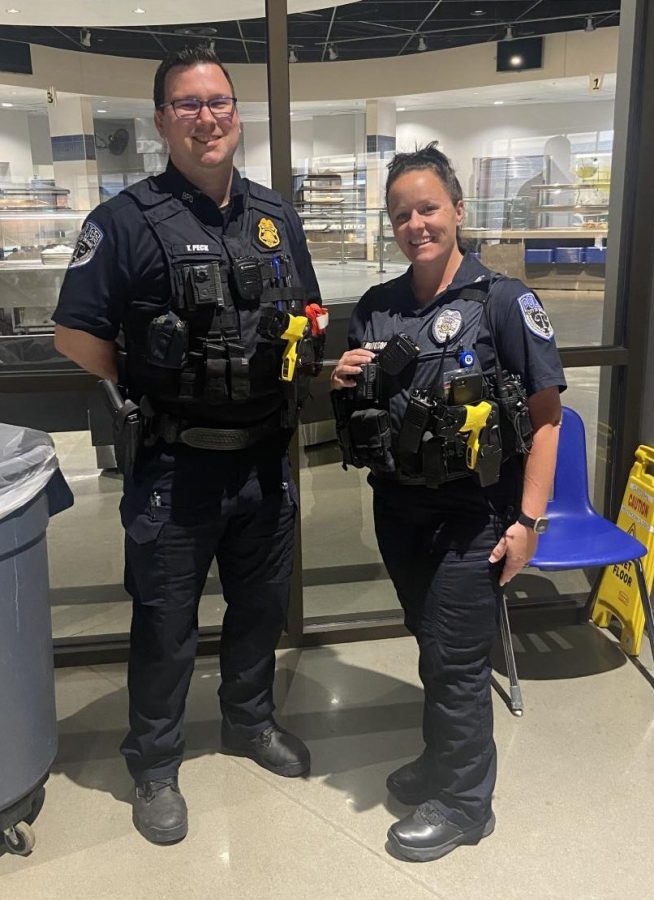 Officers Samantha Hodgson and Tanner Peck stand side by side for a photo during Lunch B, where they keep watch over students daily.
