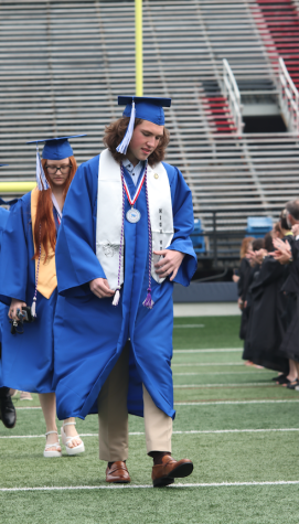 Senior Banks Austin walking to his seat before graduation was to begin. Teachers formed two lines, creating a funnel for the students to walk through. it’ll be fun to see people i know graduate. Banks said prior to the event.