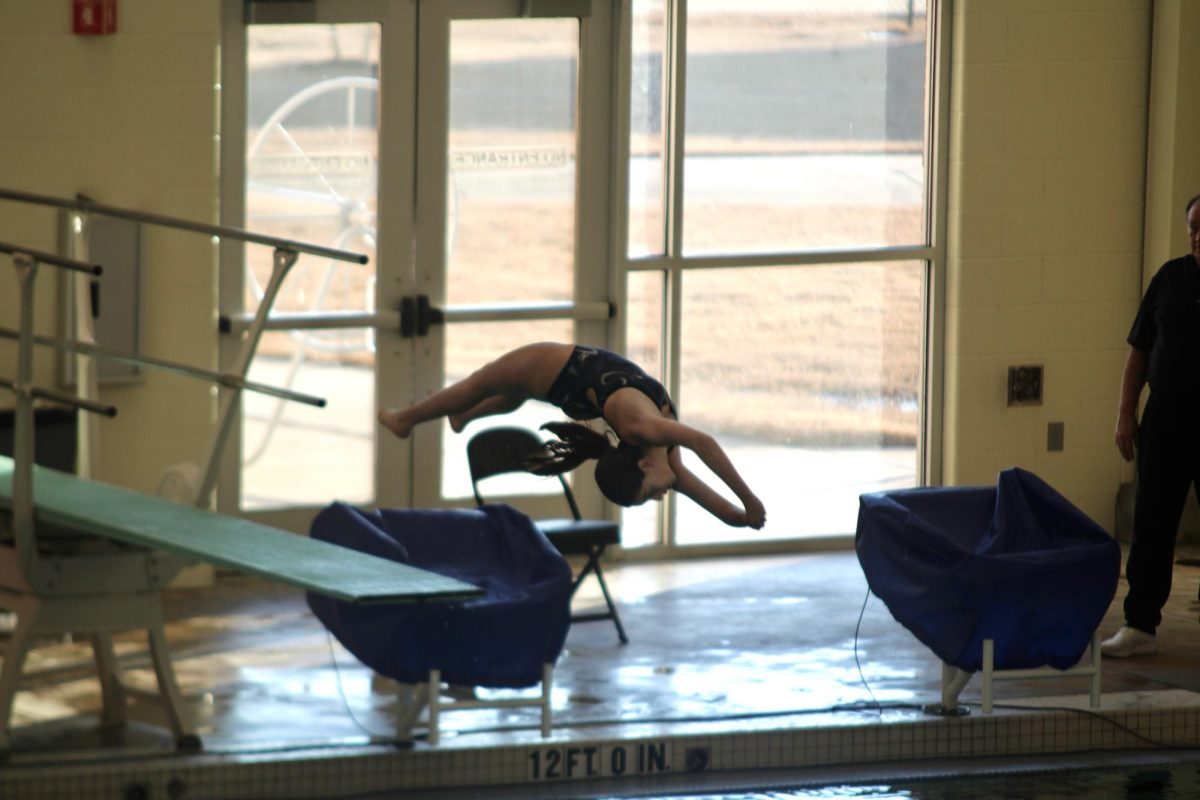 Bryant diver warming up to compete at the River Center in Benton.