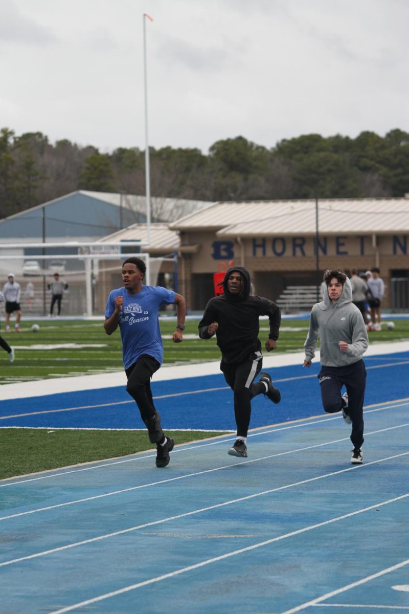 The Hornet track team completes the final stretch of their afternoon workout.