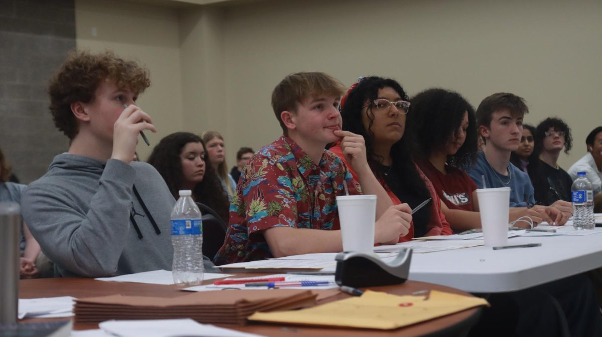The judges of the final round of debates, who are former APUSH students, think of questions to ask each president.