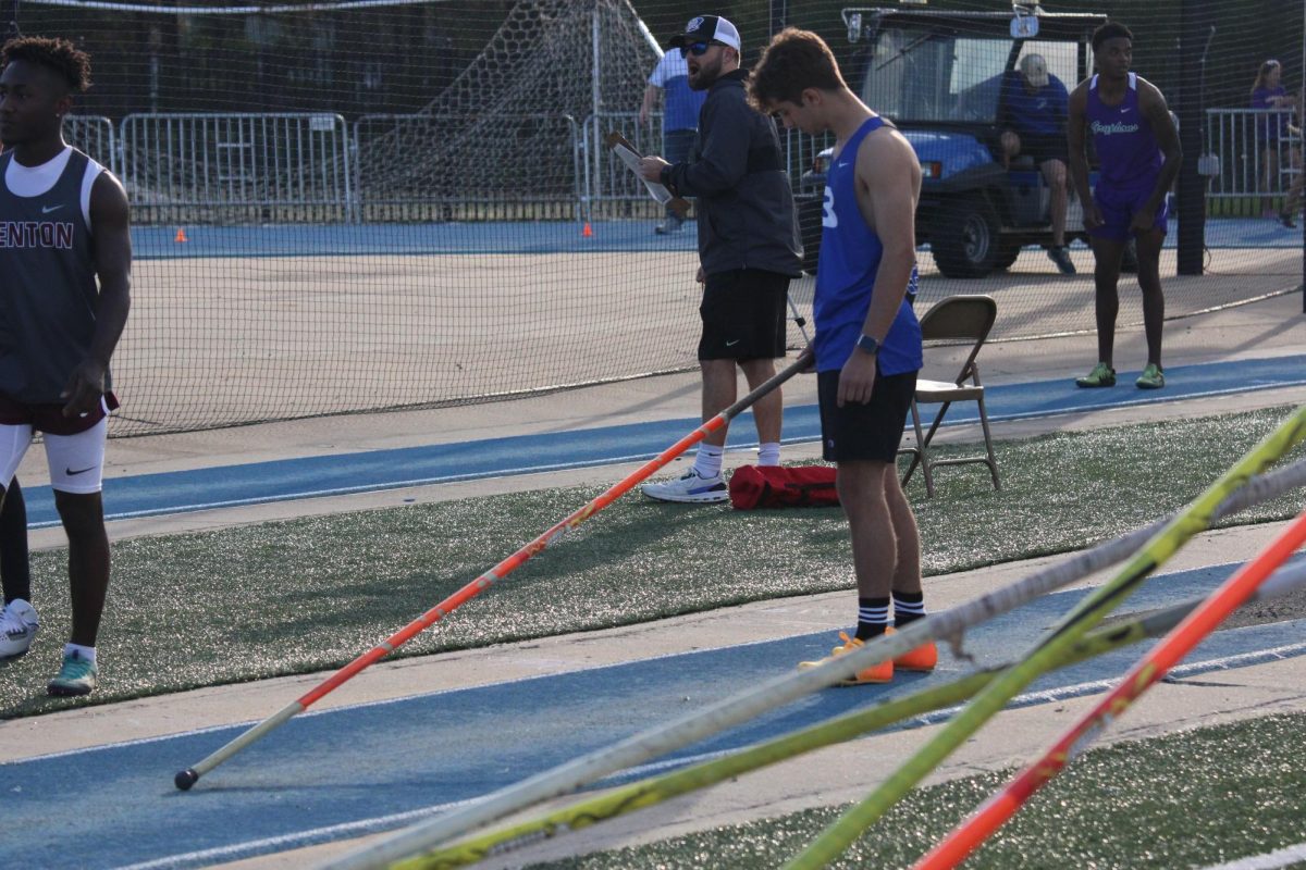 As he prepares to soar into the air, Senior Jacob Jones braces himself to compete in the pole vault event at the Bryant Track Meet on March 12th, 2024.