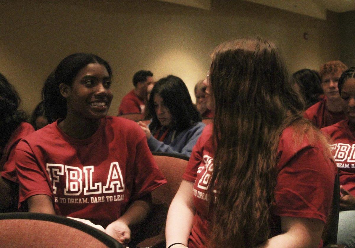 Austyn Lynch and Rowan Barela wait for the FBLA district conference to begin in the Stuttgart Grand Prairie Center auditorium.