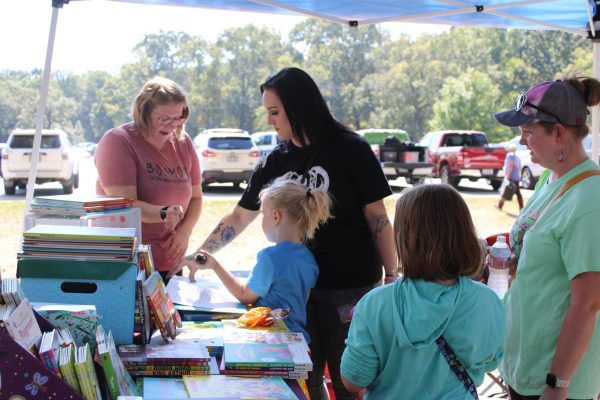 Parents take their kids to browse through children’s books at the Bryant Fall Fest on Oct. 12.