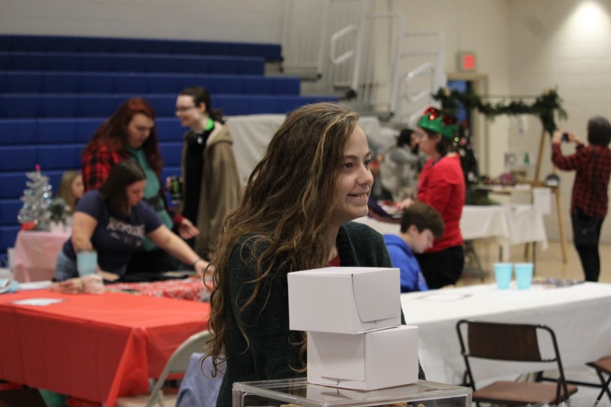 Sophomore Gabrielle Smith prepares for the Big Blue Market Dec. 7 Smith sold homemade baked goods such as fudge squares, s’mores scones, gingerbread men, chocolate chip cookies, cake pops, triple chocolate scones and sugar cookies. 