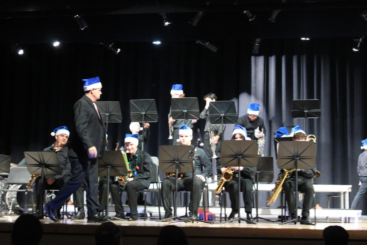 Band director Keith Matthews walks across the stage as the high school jazz band prepares for their part of the concert.