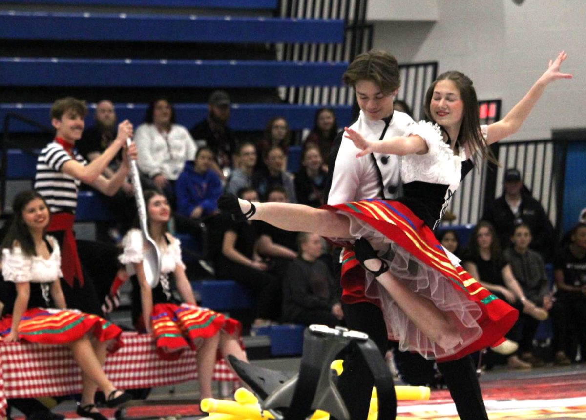 Senior Gabe Ancarrow lifts senior Gracie Chipman into the air for a duet performance during their show "On Top of Spaghetti" on Feb. 15 at Bryant Junior High School. Indoor percussion first performed their new show for Family and Friends Night the previous evening before competing the next day.