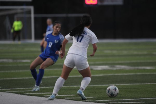 Senior Jennifer Vivar defending Rogers player from going down the field. 