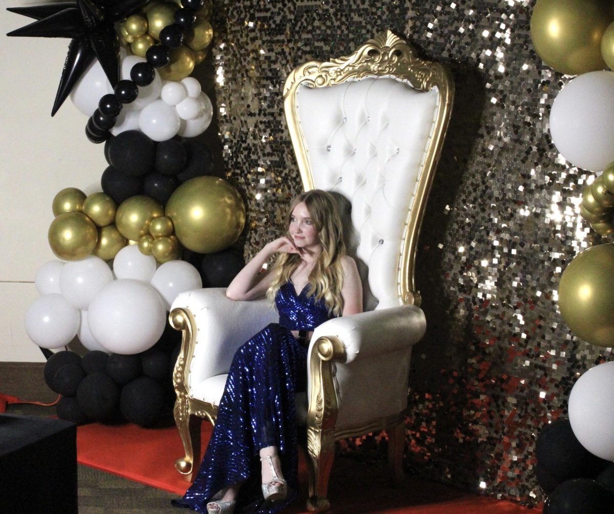 Jordan Street (10) poses for a photo in the “Great Gatsby Chair” during Prom Night at the Benton Event Center.
