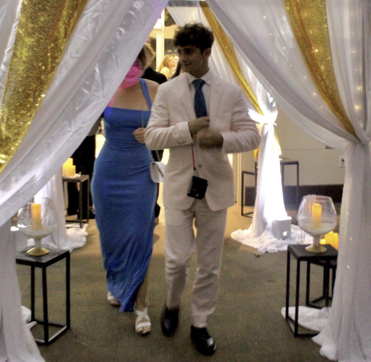 Adam Archer (12) walks through the front entrance of the Great Gatsby Prom into the ballroom of the Benton Event Center with his plus-one.