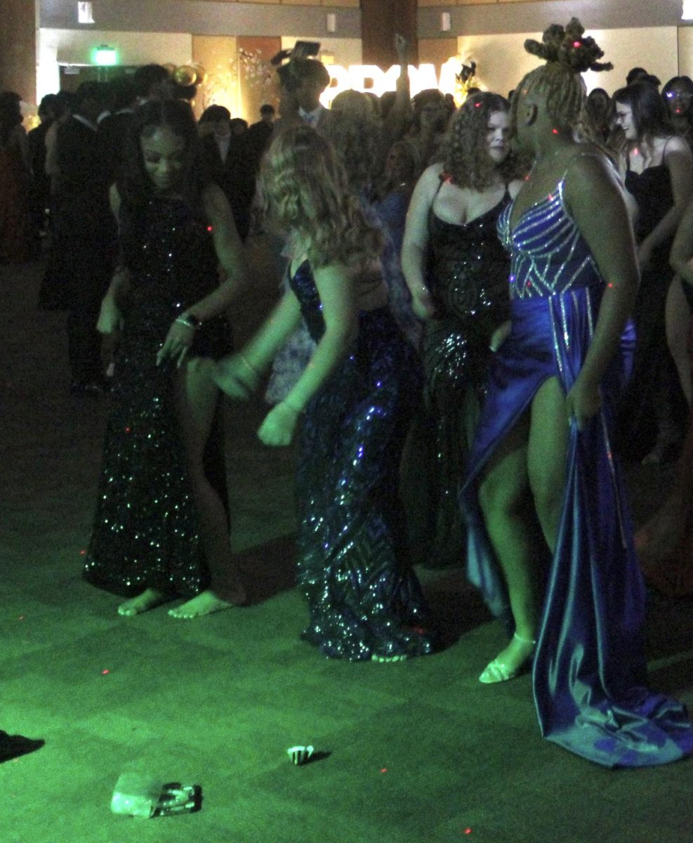 Seniors and juniors—along with some of their sophomore guests—dance together in the center of the dance floor during the 2025 Great Gatsby Prom.