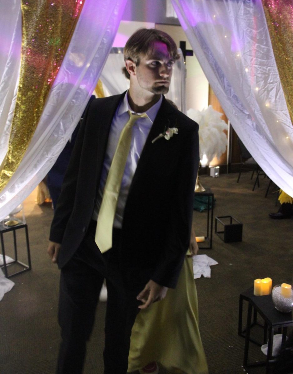 Eli Berry (12) enters the 2025 Great Gatsby Prom in a four piece suit as part of the formal attire style of the event.