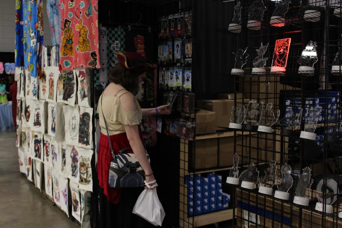Junior Erin Wright viewing merchandise while attending the Comic Con convention on Sept. 12