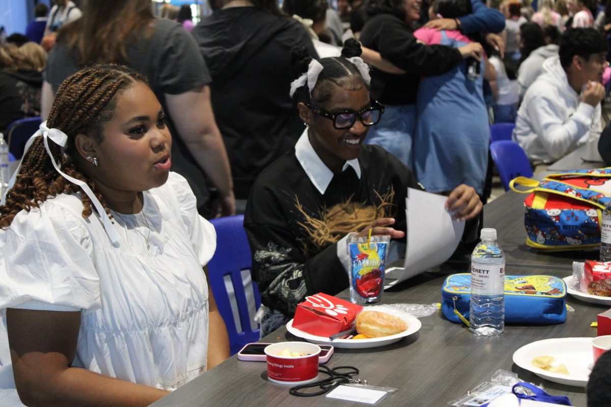 Keirsten Hence and Nia Walker laugh and chat during Senior Breakfast. Seniors were able to get out of 1st period and sign up for Senior Breakfast on the Sept. 26. Senior breakfast is one of many activities throughout the year to help seniors bond before graduating. 