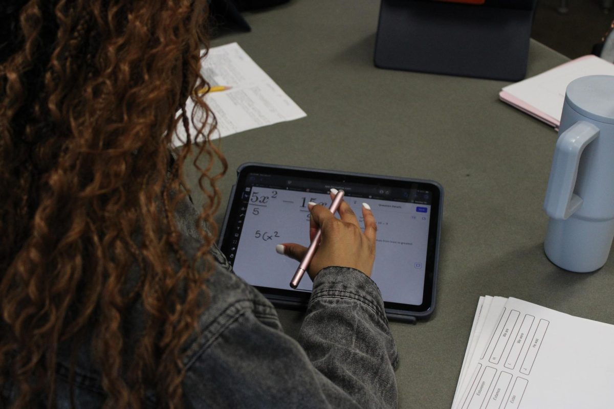 Ja’Mya Coats, junior, focuses on Algebra ll homework. Algebra ll is one of many subjects covered in Mu Alpha Theta.