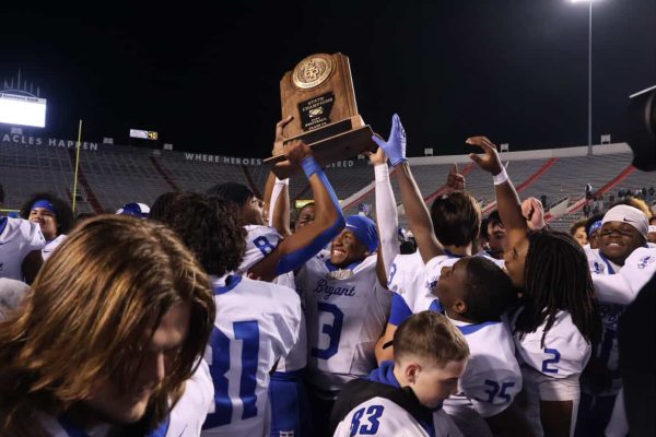 Bryant celebrates as Caleb Tucker lifts the State Championship trophy high in the air.